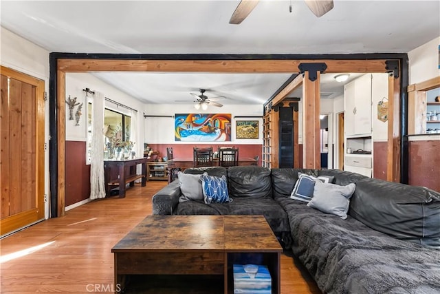 living room featuring ceiling fan and light hardwood / wood-style flooring