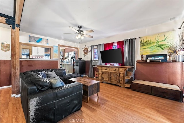 living room featuring ceiling fan and light hardwood / wood-style flooring