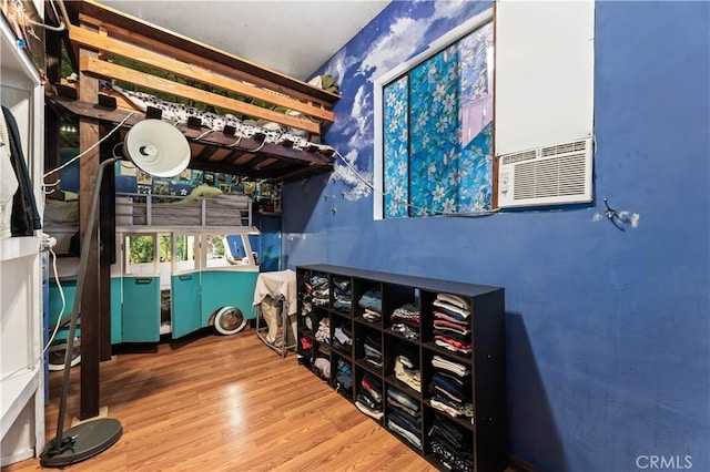 bedroom featuring hardwood / wood-style floors and cooling unit