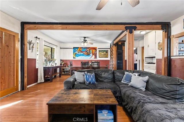 living room featuring ceiling fan and light hardwood / wood-style floors