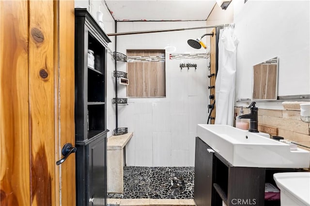 bathroom featuring toilet, vanity, and a shower with shower curtain