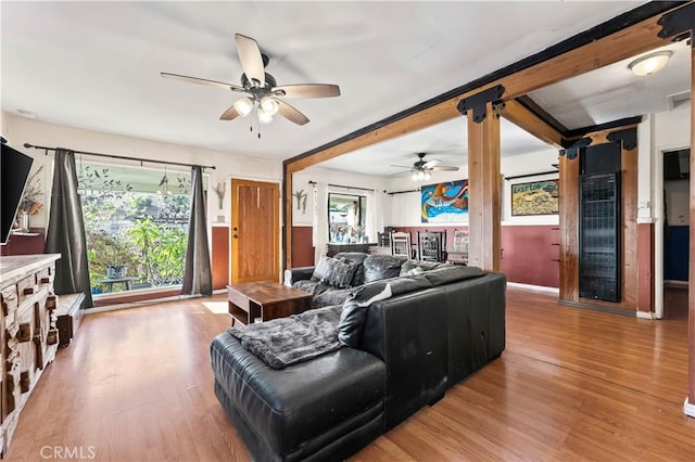 living room with light hardwood / wood-style flooring and ceiling fan