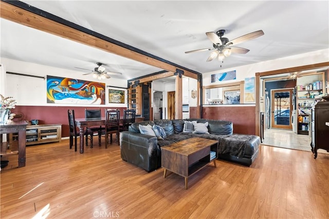 living room with light hardwood / wood-style floors and ceiling fan