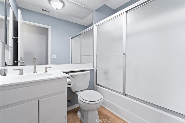 full bathroom with vanity, toilet, and shower / bath combination with glass door