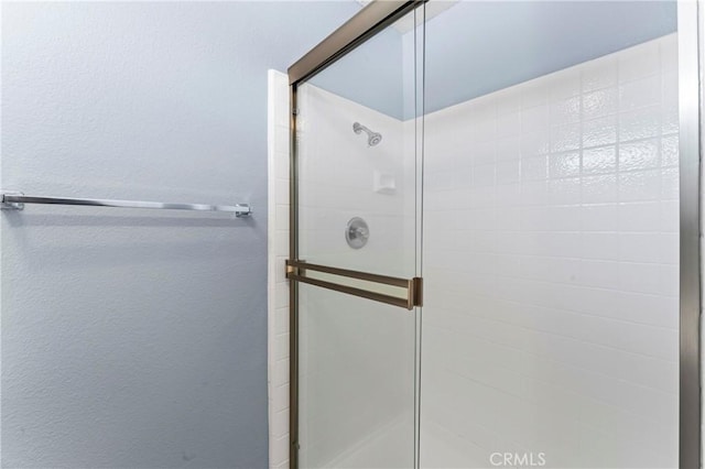 bathroom with a shower with shower door