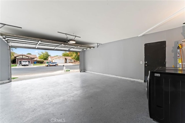 garage featuring washer and dryer and a garage door opener