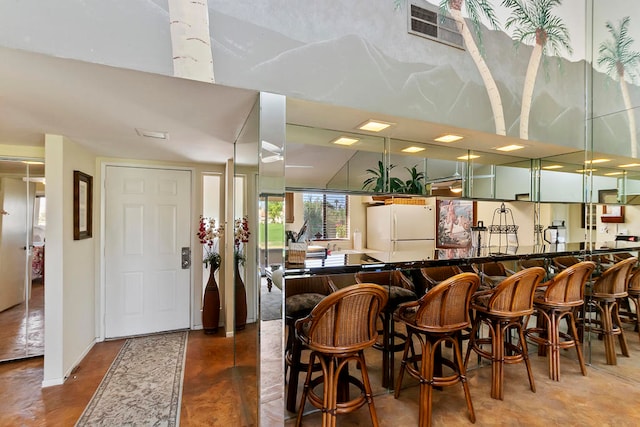 interior space with green cabinets and white fridge