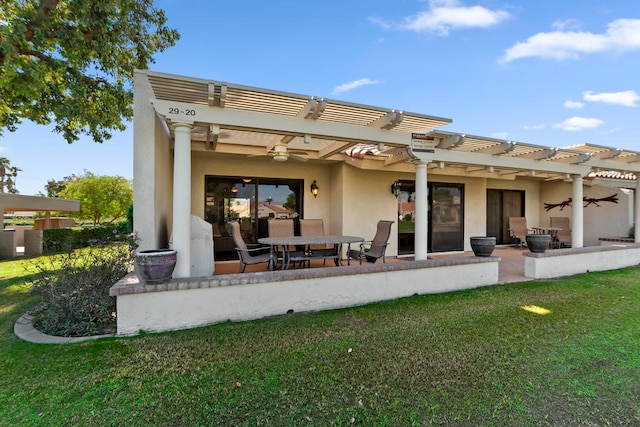 rear view of house with ceiling fan, a patio area, a pergola, and a yard