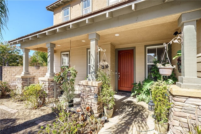 view of exterior entry featuring covered porch