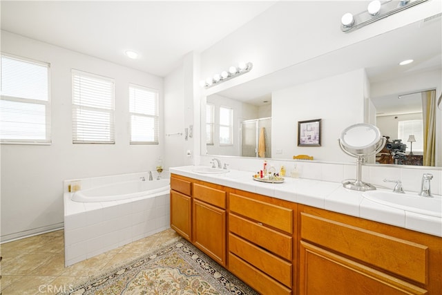 bathroom with tile patterned floors, vanity, and separate shower and tub