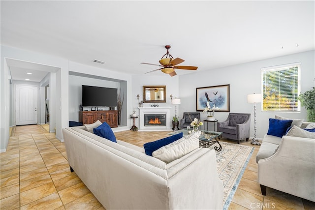 tiled living room featuring ceiling fan