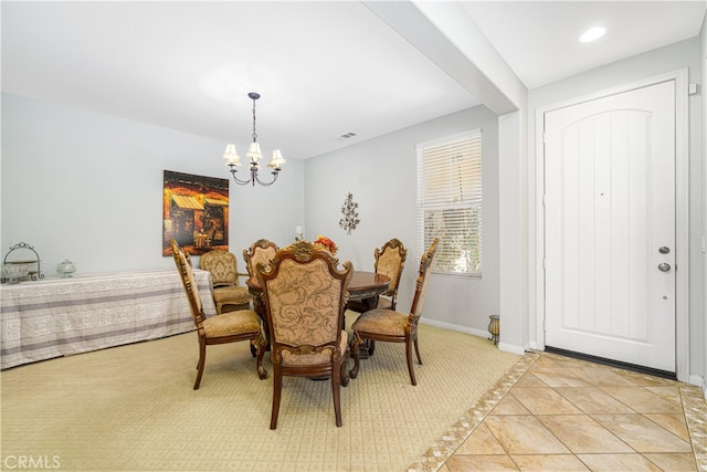 dining room with a chandelier and light tile patterned floors