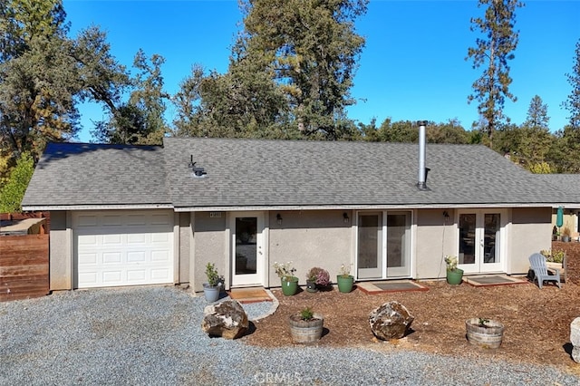 ranch-style house with french doors and a garage