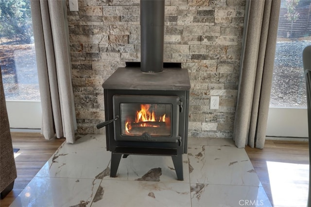 room details with a wood stove and hardwood / wood-style floors