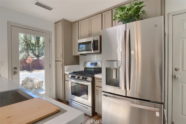 kitchen featuring appliances with stainless steel finishes, gray cabinetry, and wood-type flooring