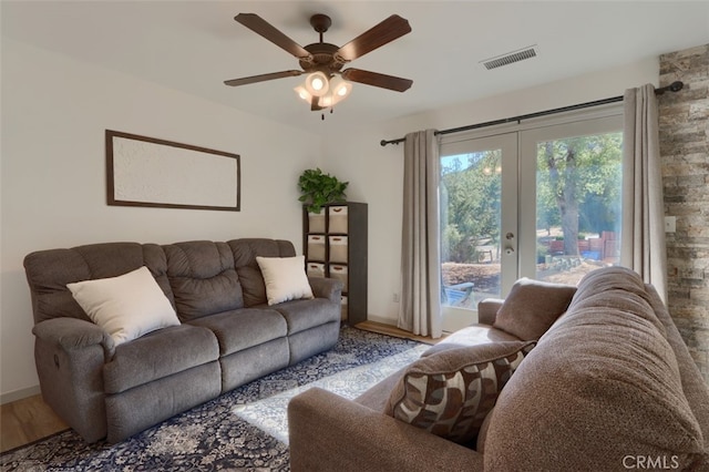 living room with french doors, ceiling fan, and wood-type flooring