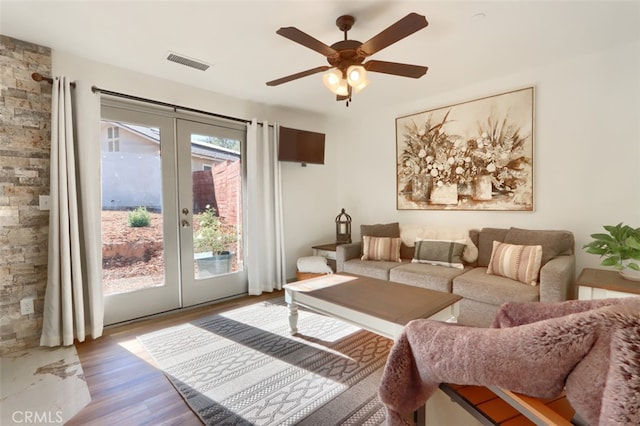 living room featuring french doors, hardwood / wood-style floors, and ceiling fan