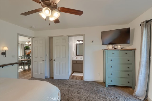 bedroom with ensuite bathroom, light wood-type flooring, and ceiling fan