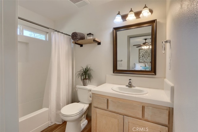 full bathroom featuring toilet, wood-type flooring, shower / tub combo with curtain, vanity, and ceiling fan