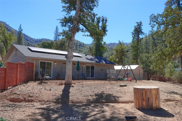 back of property with a mountain view