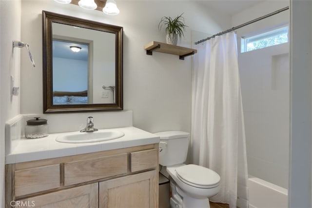 full bathroom featuring vanity, shower / bath combination with curtain, and toilet