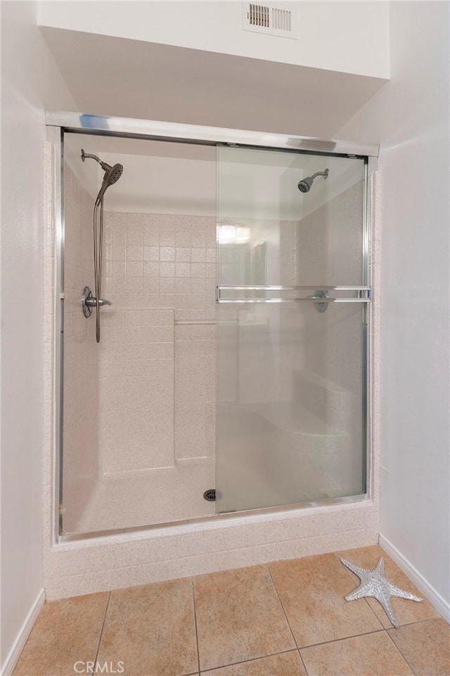 bathroom featuring tile patterned flooring and a shower with door