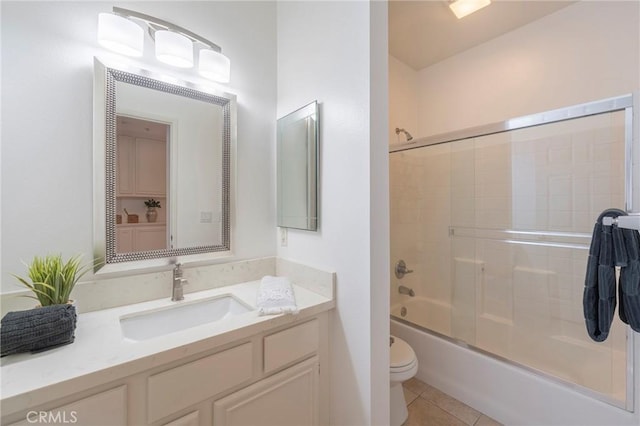 full bathroom with vanity, tile patterned floors, shower / bath combination with glass door, and toilet