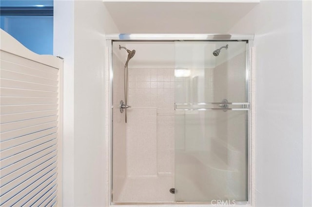 bathroom with a shower with shower door