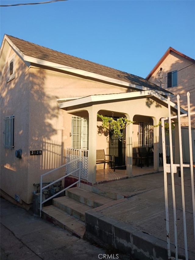 back of house featuring covered porch