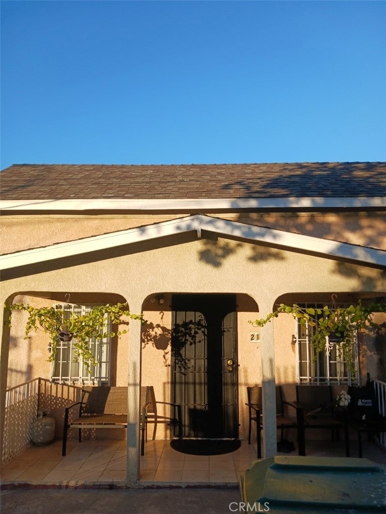 entrance to property featuring a patio