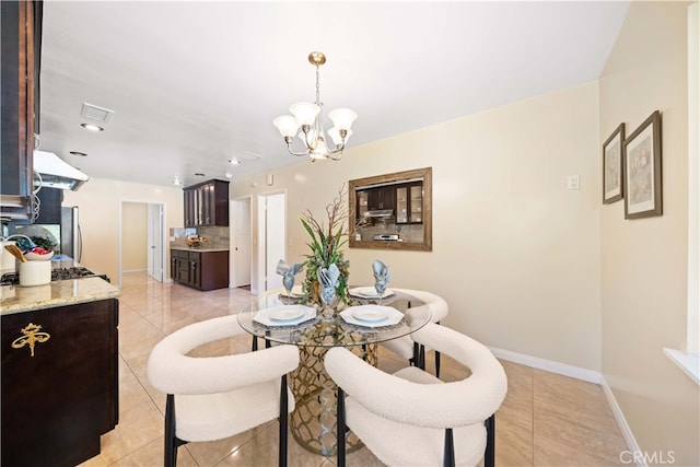 tiled dining area featuring a notable chandelier