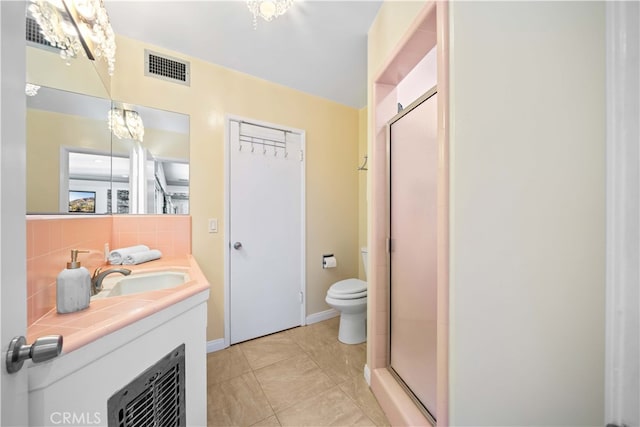 bathroom featuring backsplash, tile patterned floors, toilet, and walk in shower