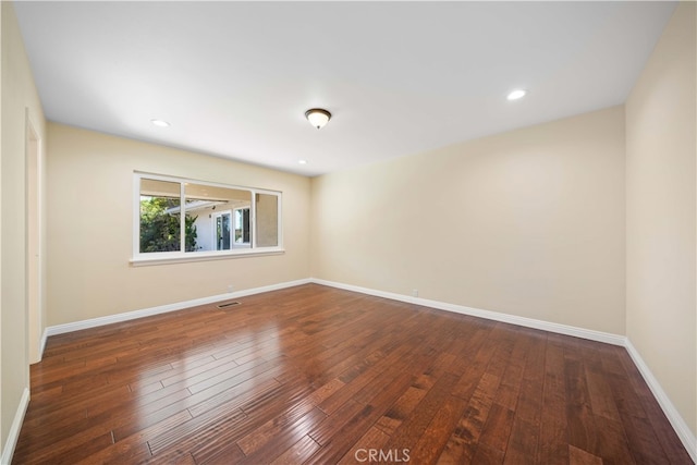 spare room featuring dark hardwood / wood-style floors