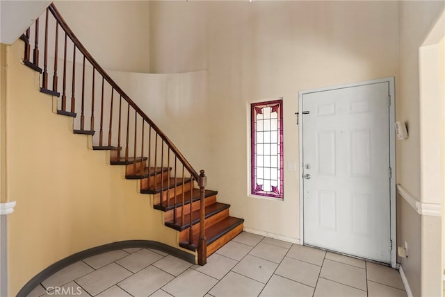 entryway featuring a towering ceiling