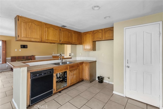 kitchen featuring tile counters, sink, black dishwasher, kitchen peninsula, and light tile patterned flooring