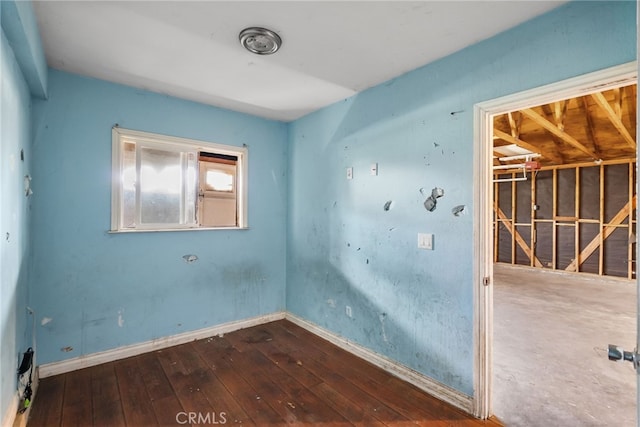 unfurnished room featuring dark hardwood / wood-style flooring