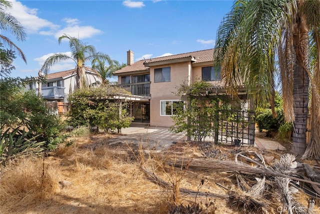 back of house with a patio