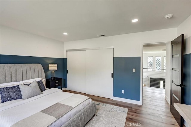 bedroom featuring hardwood / wood-style flooring and a closet