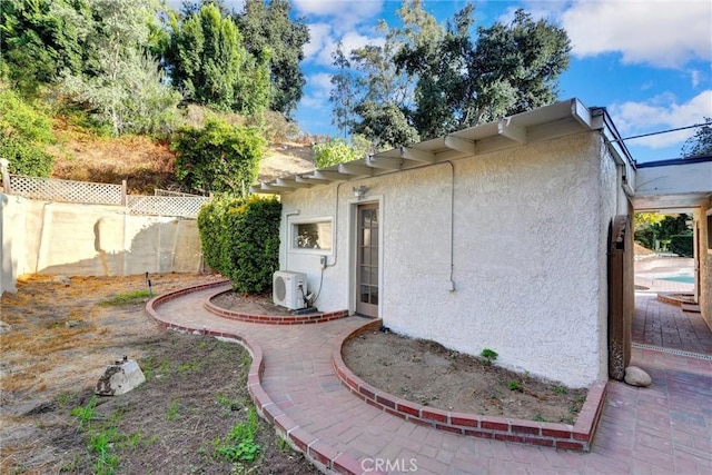 exterior space featuring ac unit and a patio