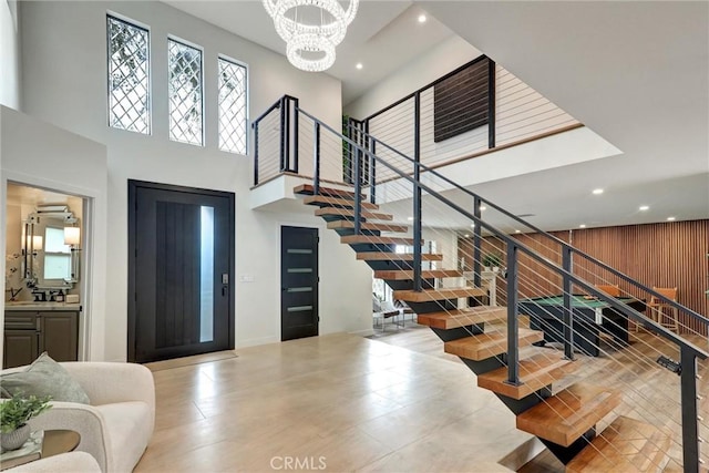 foyer featuring a notable chandelier and a towering ceiling