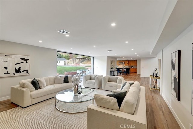 living room with light hardwood / wood-style flooring