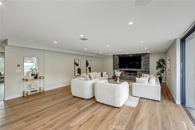 living room featuring a fireplace and light hardwood / wood-style flooring