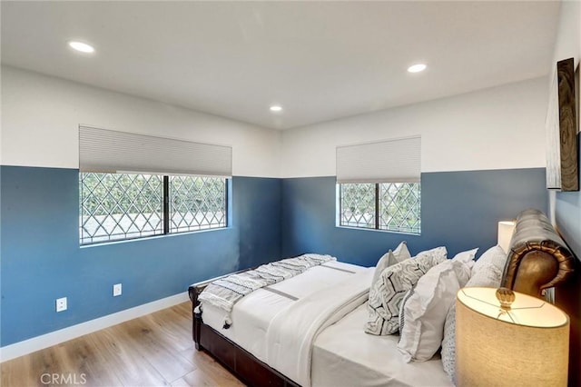 bedroom featuring light hardwood / wood-style floors and multiple windows