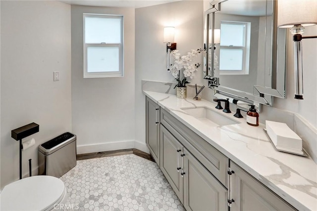 bathroom featuring tile patterned flooring, vanity, and toilet