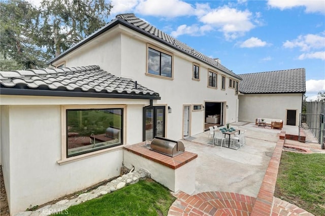 rear view of property featuring a patio area and an outdoor living space