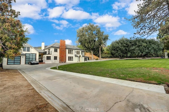 view of front of property with a front yard and a garage