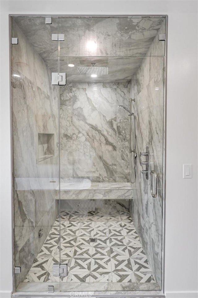 bathroom with a shower with shower door