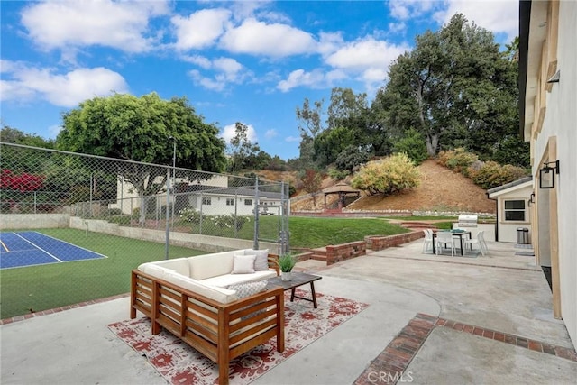 view of patio with an outdoor living space and tennis court