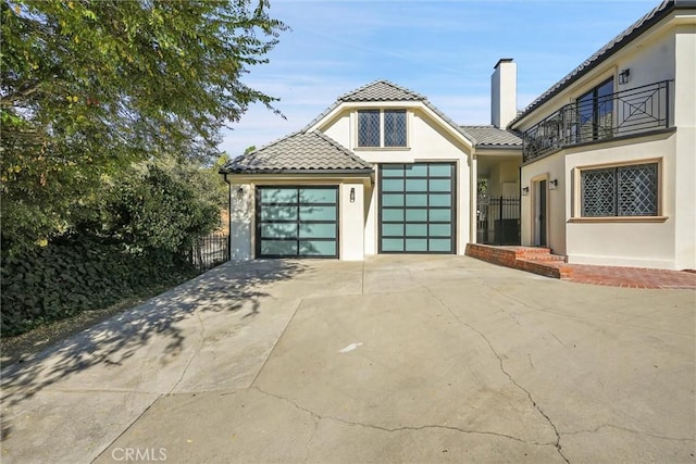 view of front of property featuring a balcony and a garage