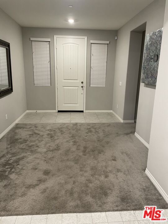 entryway featuring light carpet